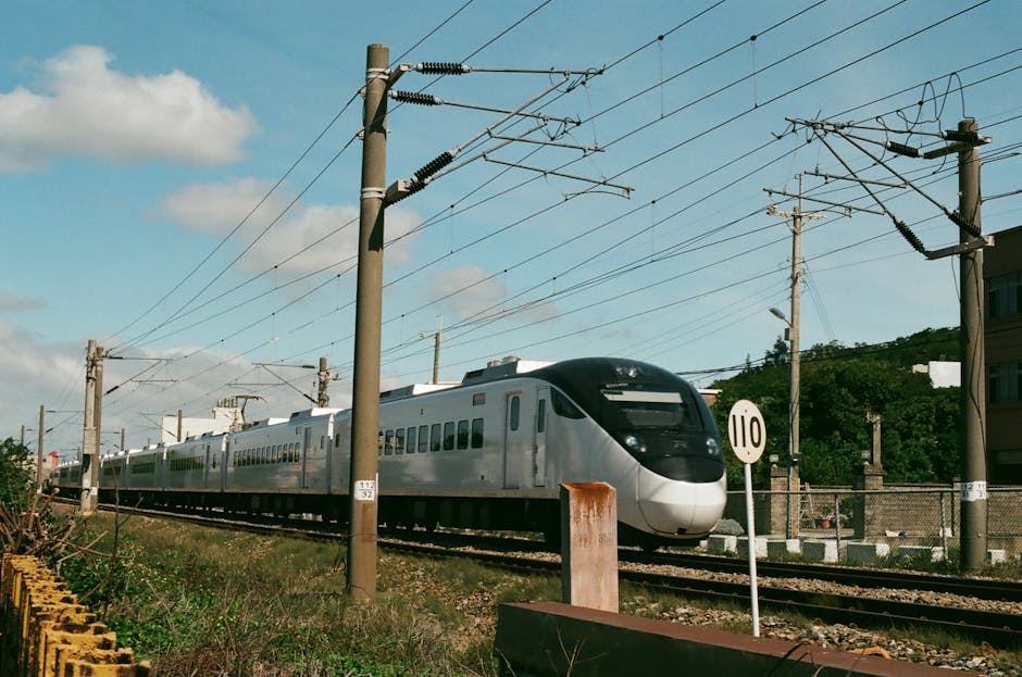 A high-speed train moving through scenic countryside, similar to the AREX Express to Seoul