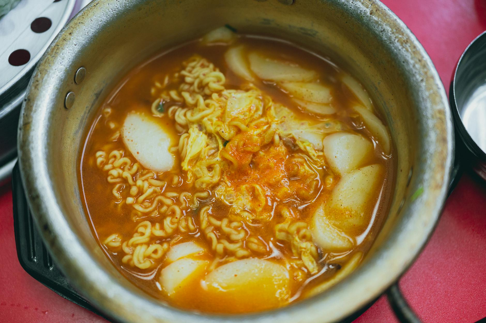 Bright red tteokbokki spicy rice cakes served at a Seoul market stall