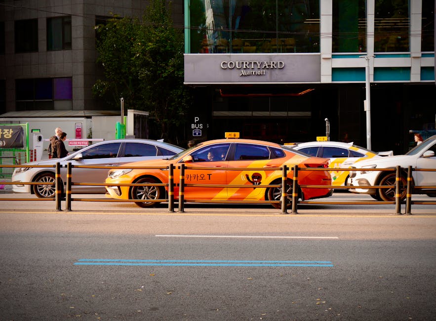 Orange Korean taxi waiting in front of a Seoul hotel for an airport transfer fare