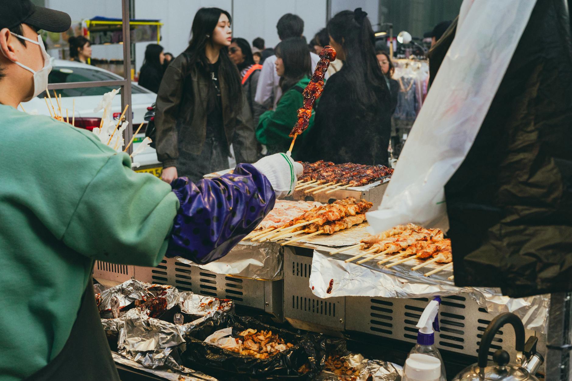 Seoul food street at night with neon signs and BBQ restaurants