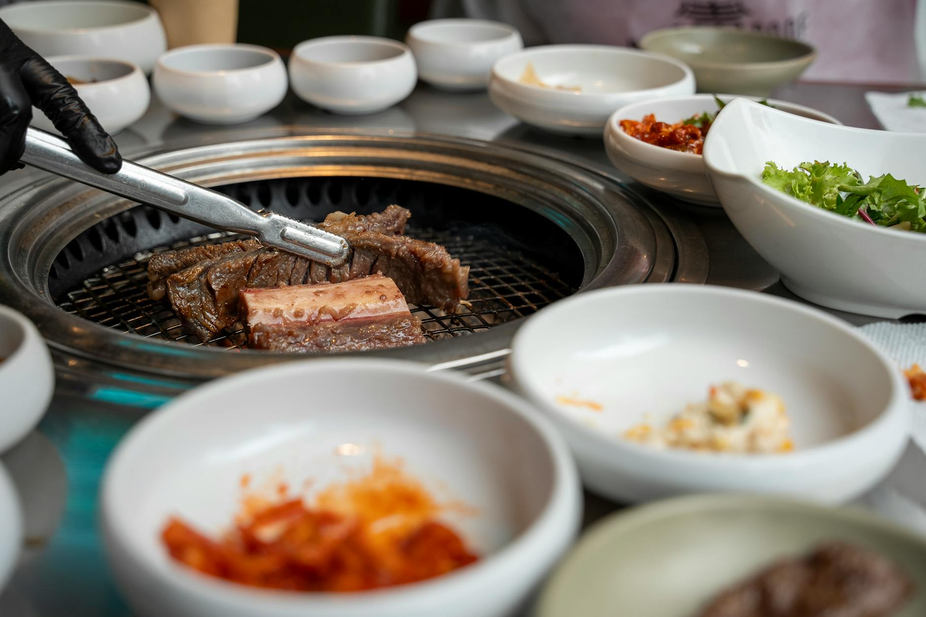 Complete Korean BBQ meal spread with rice soup and grilled meat