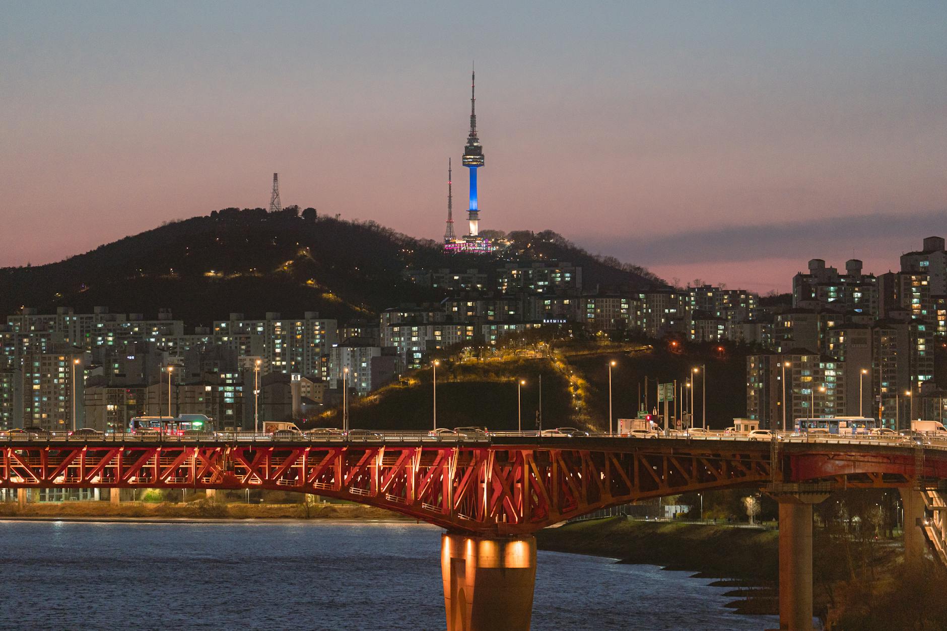 N Seoul Tower lit up at night with city views from Namsan Mountain