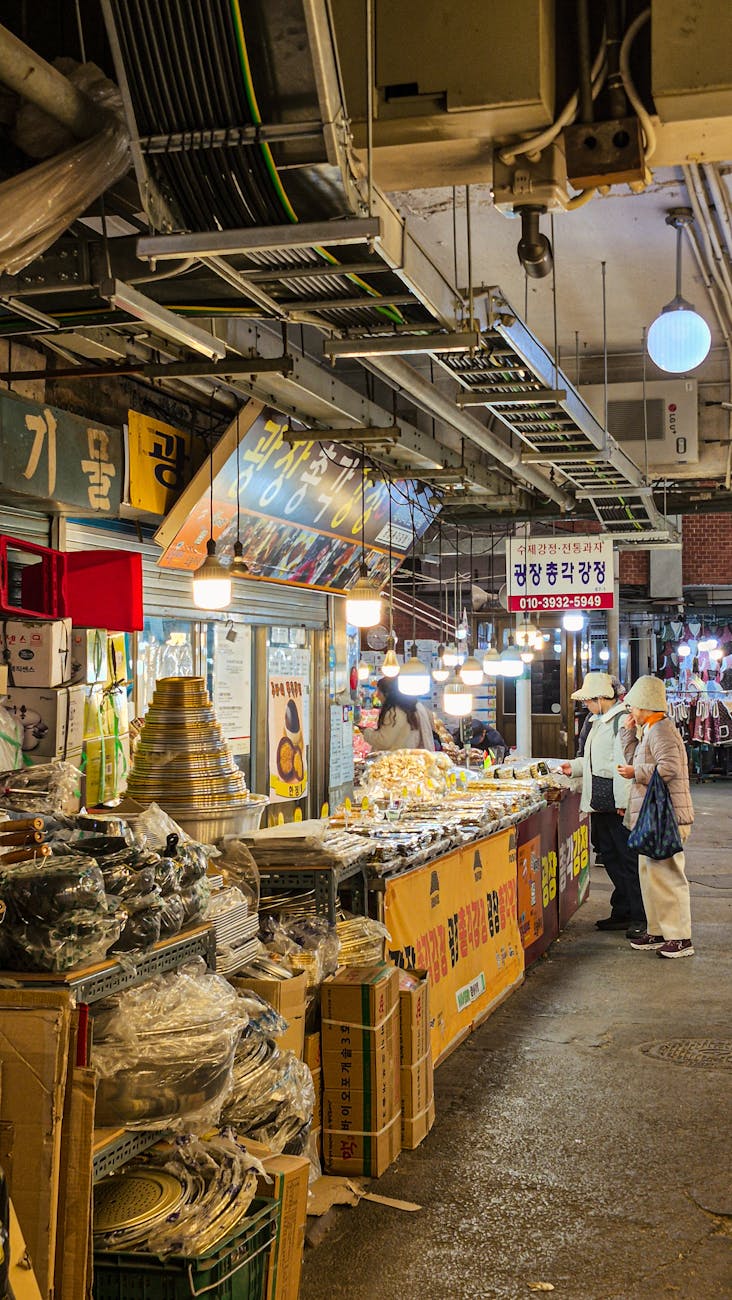 Seoul street food market at night with colorful stalls and visitors
