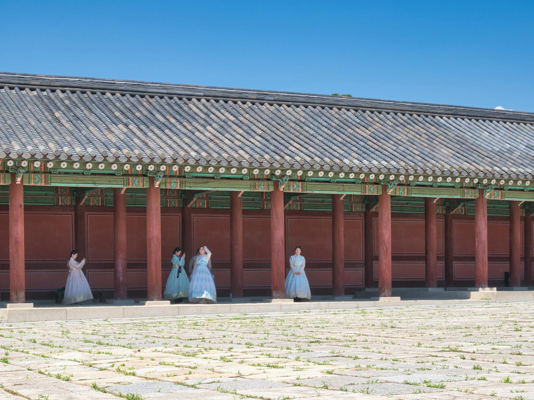 Visitors wearing traditional hanbok at a Korean palace in Seoul