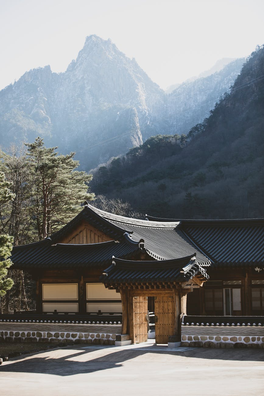 Traditional Korean temple surrounded by mountain forest