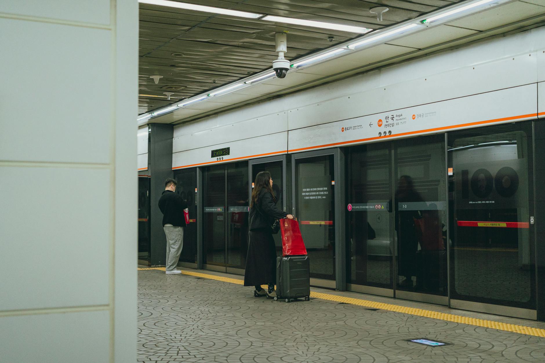 Modern Seoul subway station with safety features and CCTV cameras for passenger security