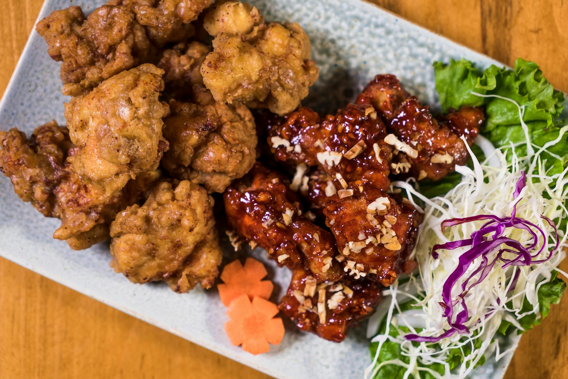 Korean fried chicken pieces glazed in spicy sauce on a plate