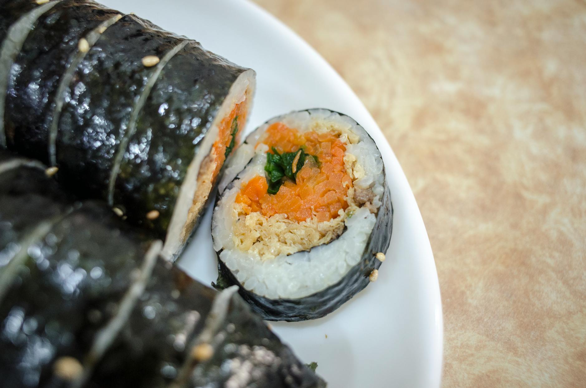 Tray of mayak kimbap mini rice rolls at a Korean street food stall