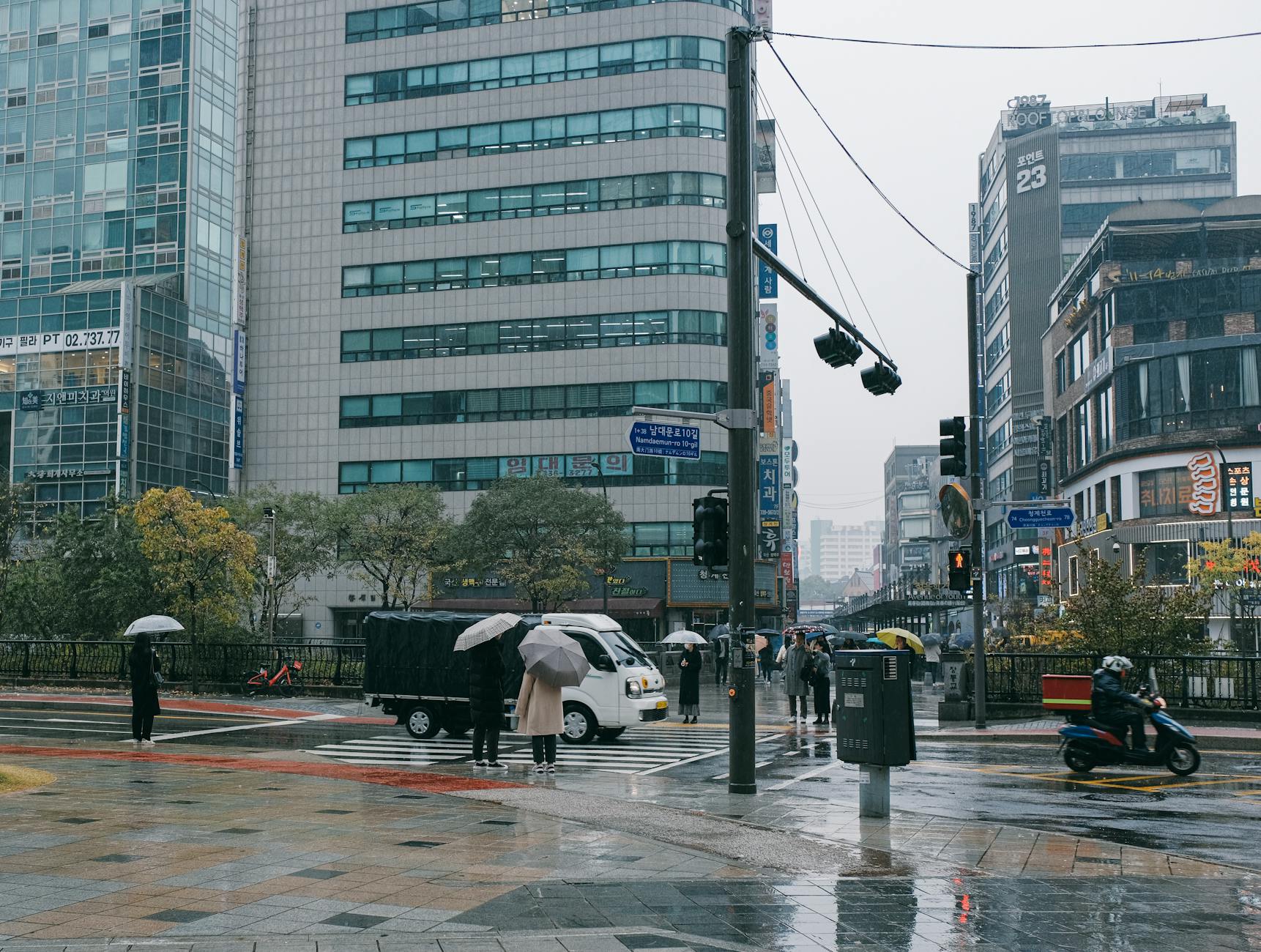 Seoul rainy street where commuters hail taxis at night