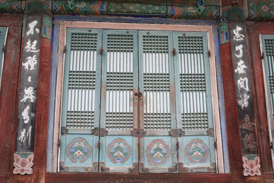 Traditional Korean temple door with intricate wooden carvings and painted patterns