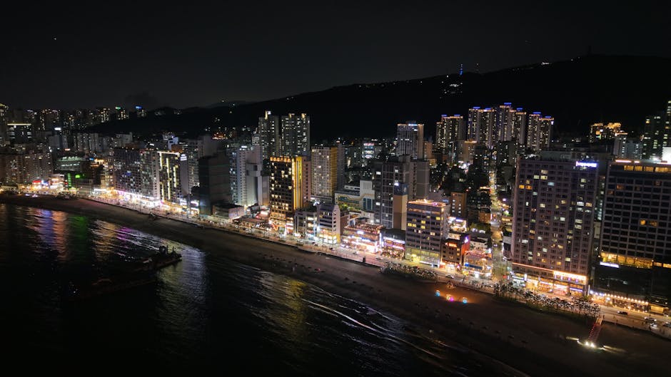 Busan skyline lit up at night above the water
