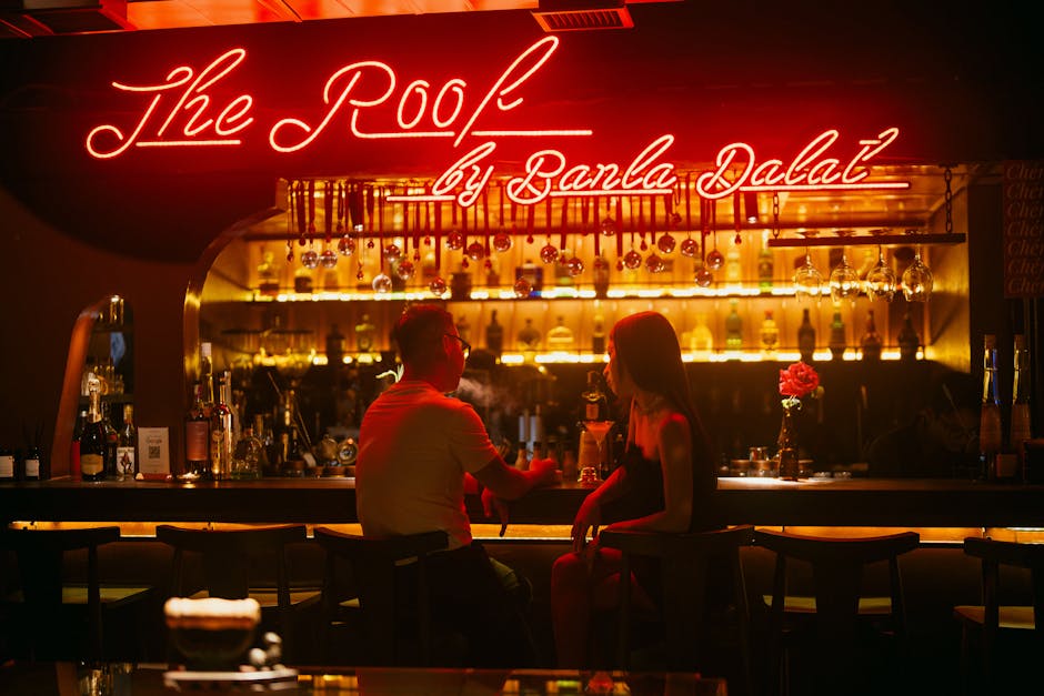 Lively evening atmosphere at a Seoul rooftop bar with patrons enjoying drinks