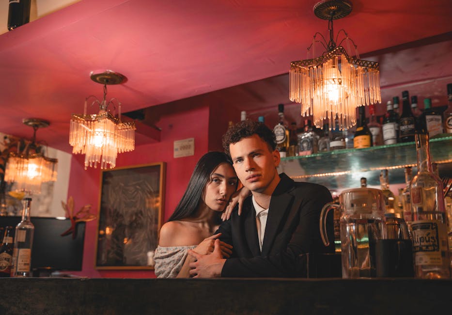 Stylish couple posing at a sophisticated Seoul bar with warm ambient lighting
