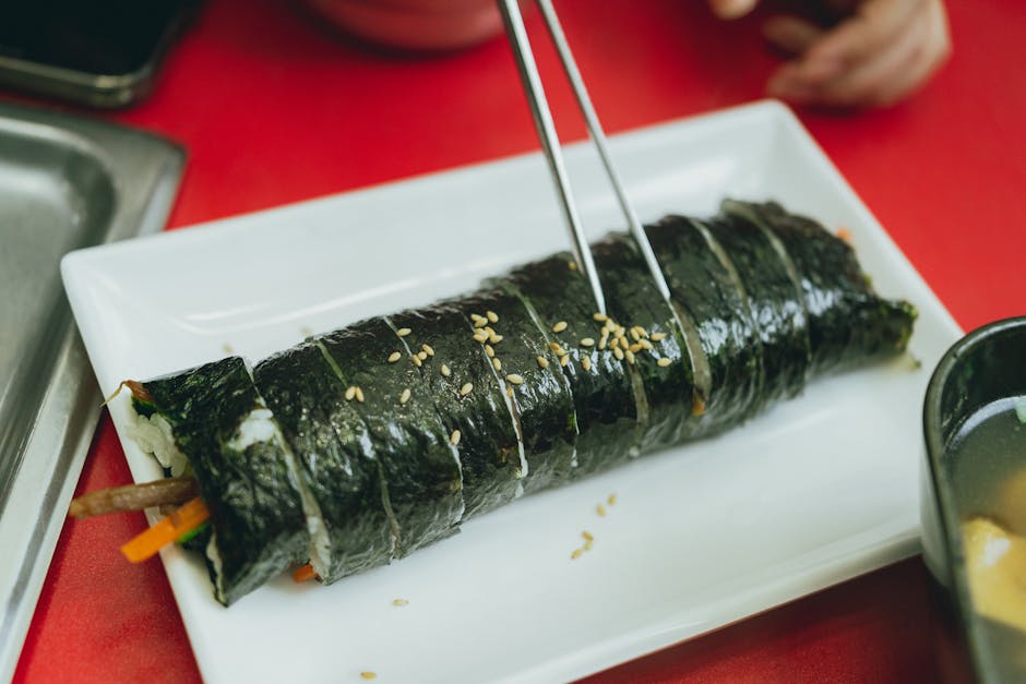 Delicious Korean kimbap served on a white plate, a popular Seoul cheap meal