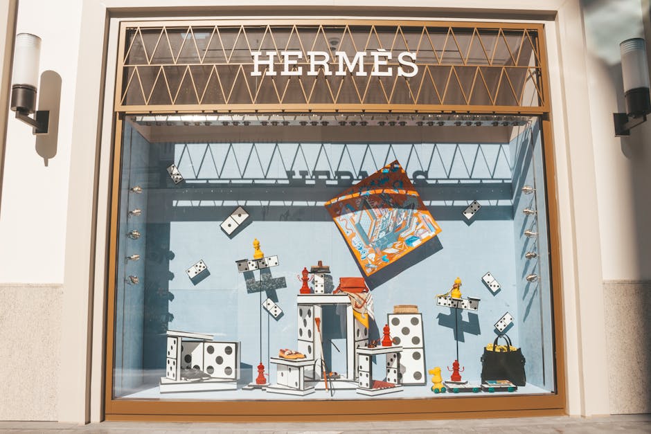 Artistic Hermès window display at a luxury Seoul duty-free store