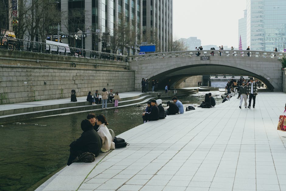People walking along the sunken Cheonggyecheon stream path in central Jongno