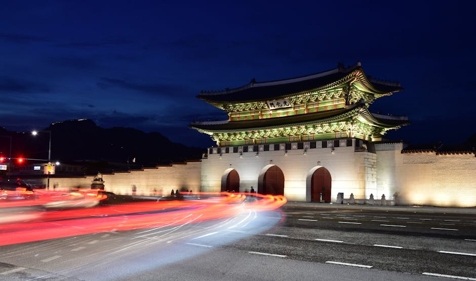 Illuminated Gwanghwamun Gate with dazzling light trails at night in Jongno