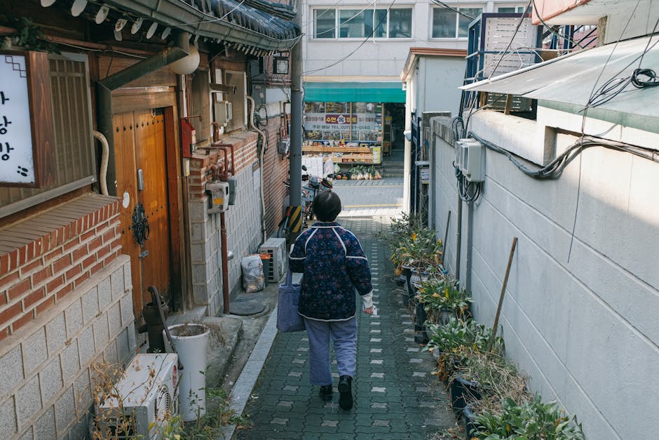 Woman walking down a traditional Seoul alley, common K-drama scene location