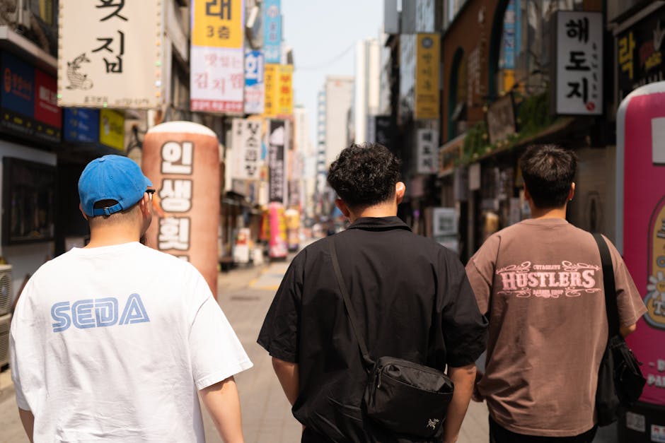 Three people walking on vibrant bustling Korean shopping street fashion