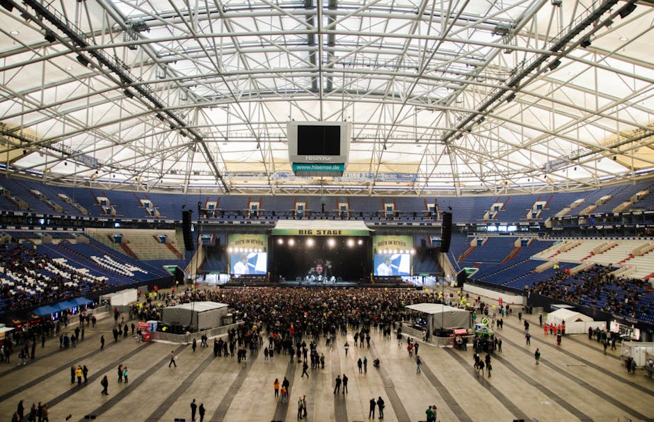Wide shot of a crowded K-pop concert in a large indoor Seoul arena