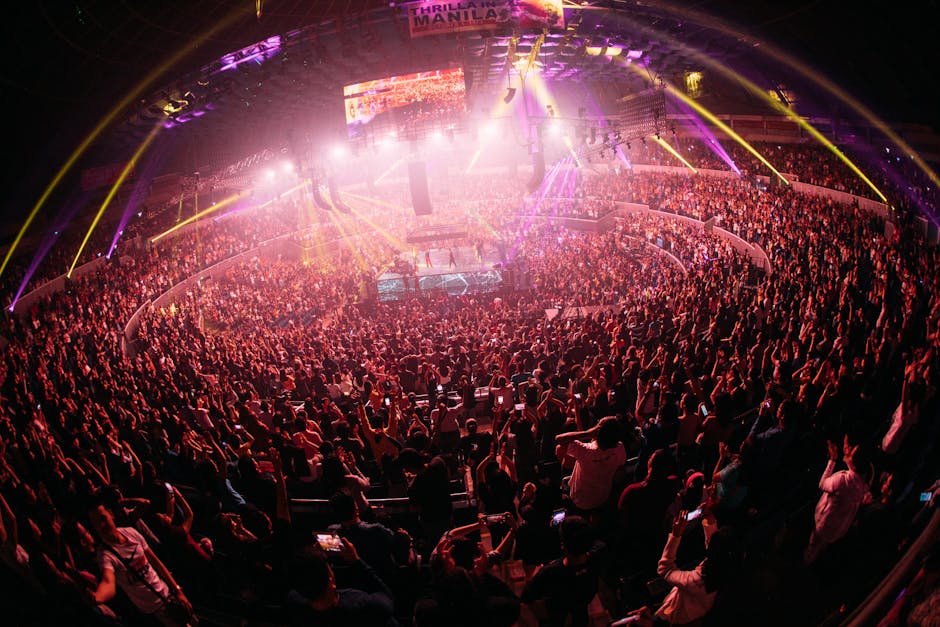 Vibrant K-pop crowd enjoying live concert in a bustling Seoul arena at night