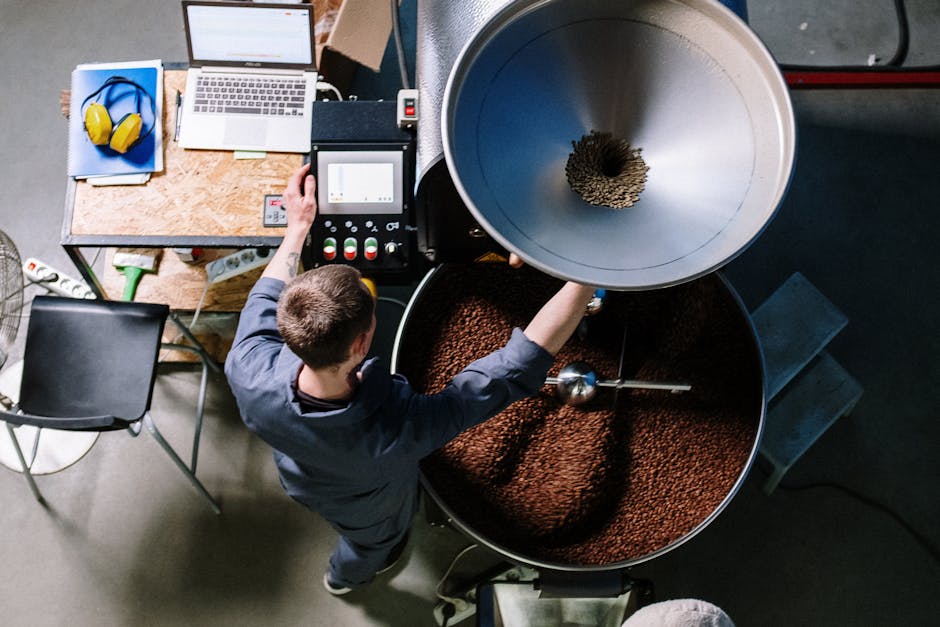 Worker in a Seongsu-dong coffee roastery operating equipment processing fresh beans