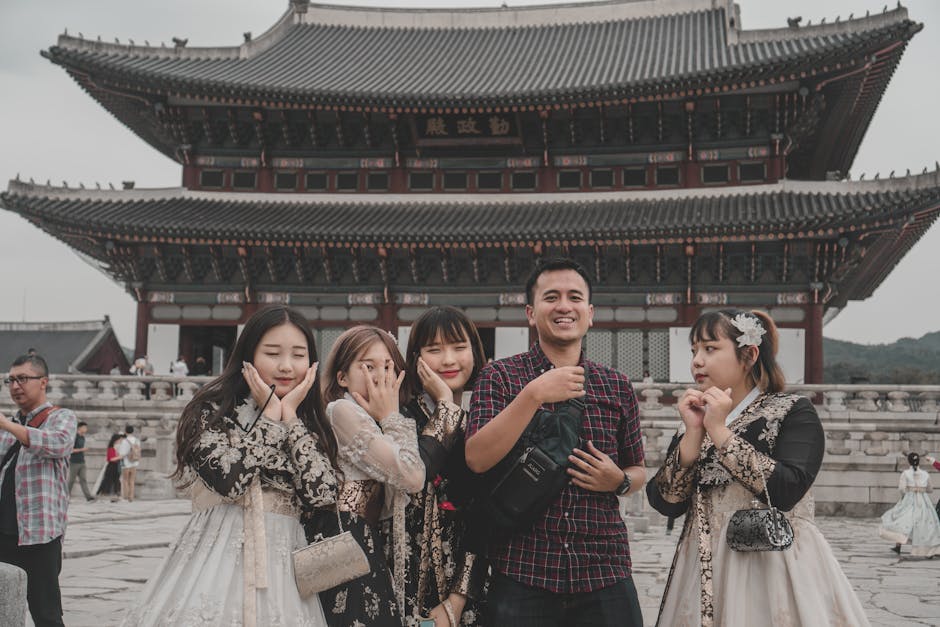Tourists posing at Gyeongbokgung Palace, a Discover Seoul Pass attraction