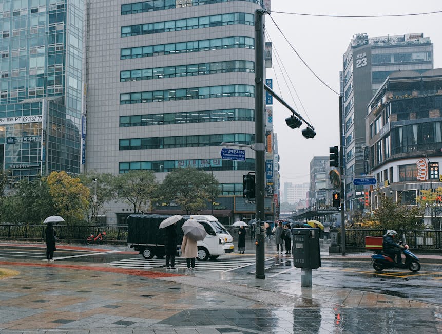 Rainy day in Seoul bustling streets with skyscrapers and pedestrians