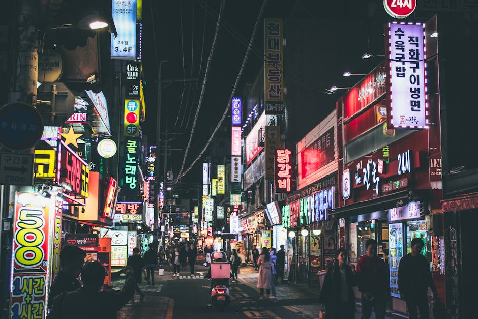Lively Itaewon street at night with neon signs and people walking