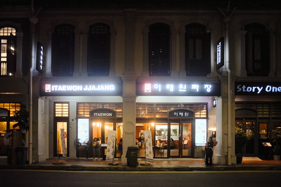 Night scene of Itaewon Yongsan restaurant illuminated with neon signage on a bustling Seoul street