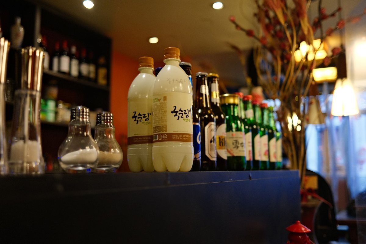 Soju and makgeolli on a table at a Seoul bar at night