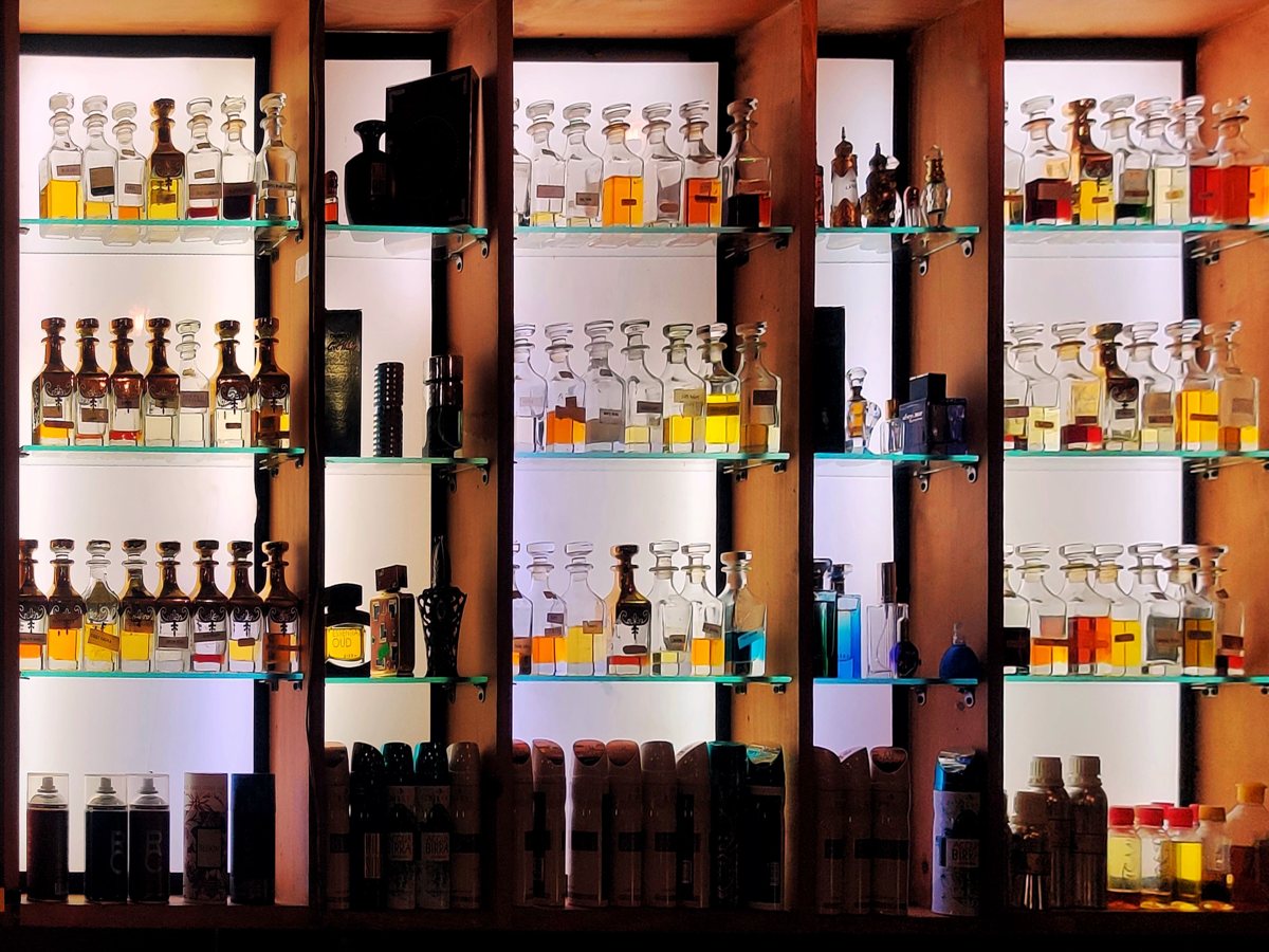 Rows of luxury perfume bottles on a bright duty-free fragrance counter in Seoul