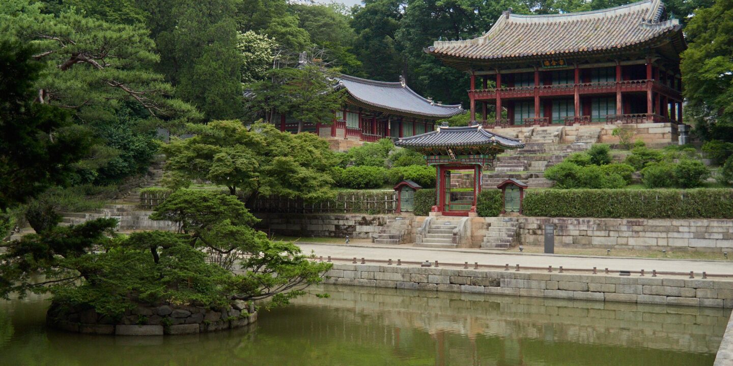 Buyongji, a square pond in the Secret Garden, with the two-storey Juhamnu pavilion on the wooded slope above it