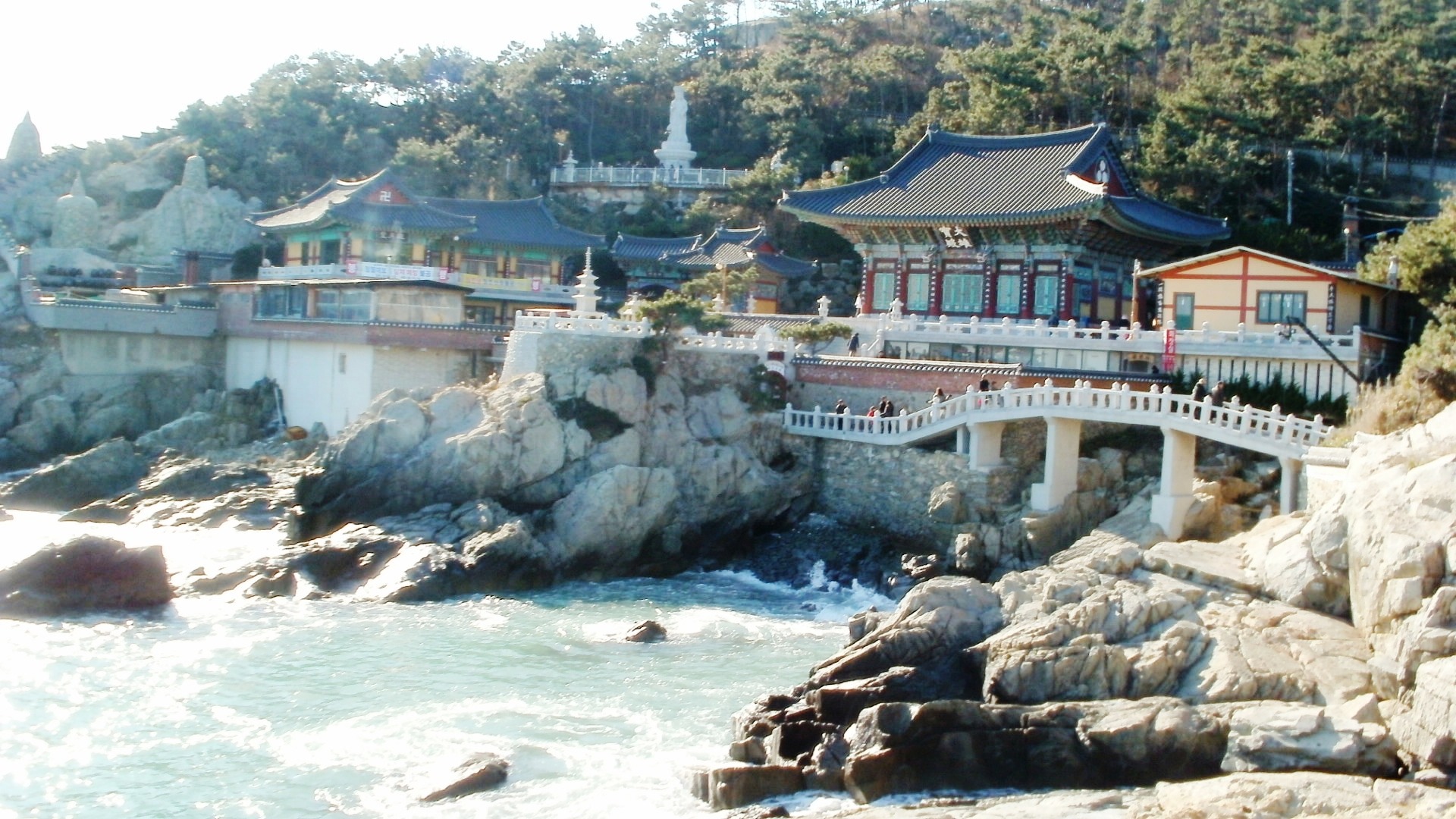 Haedong Yonggungsa temple buildings and a stone bridge built on rocks above the sea in Busan