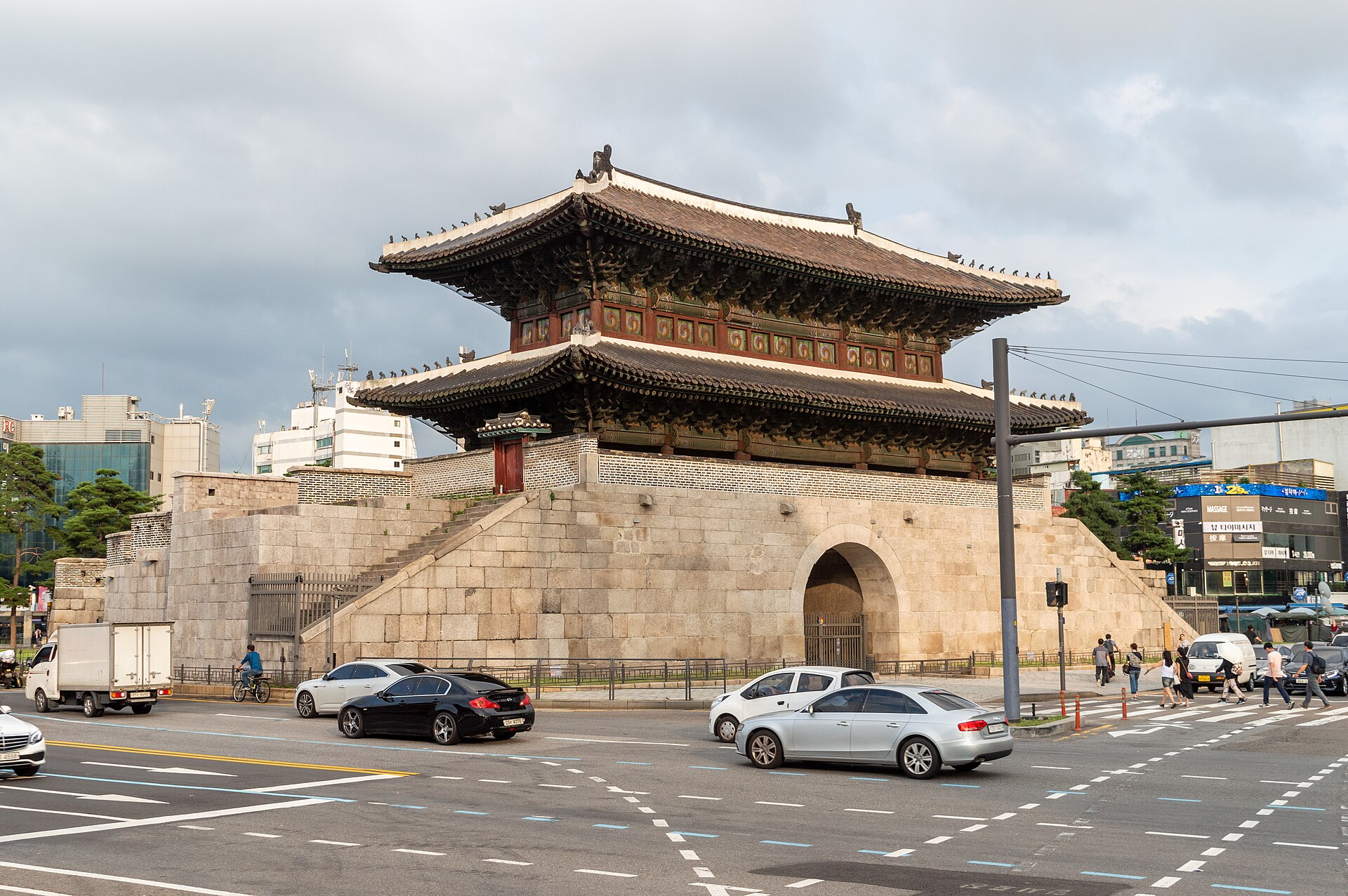 Heunginjimun gate in Seoul on a stone platform surrounded by traffic lanes