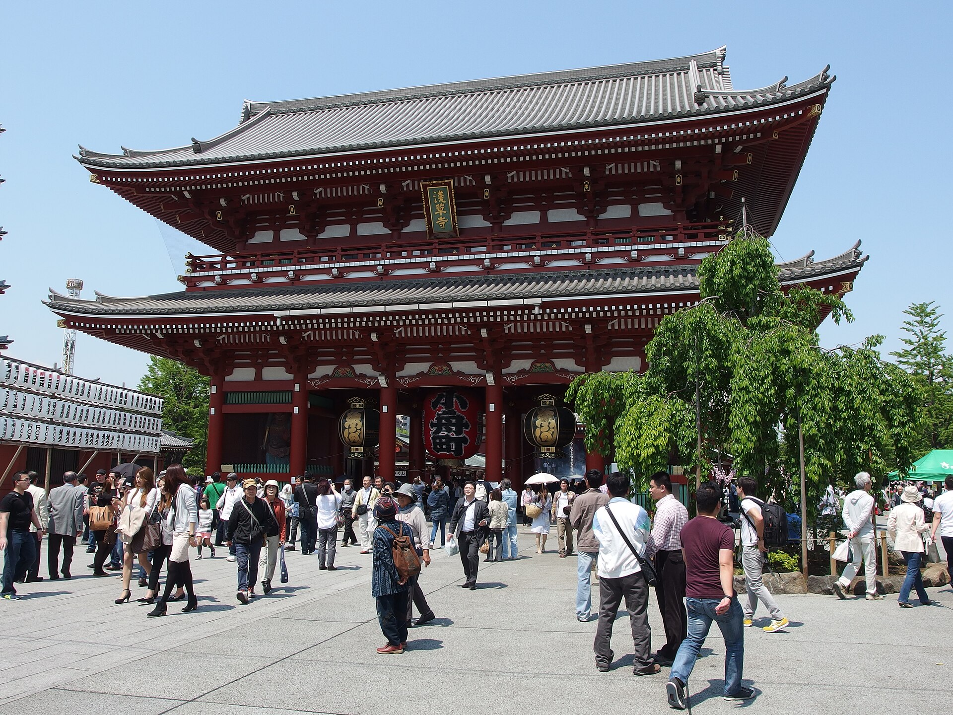 The red Hozomon gate at Senso-ji temple in Asakusa with visitors crossing the forecourt
