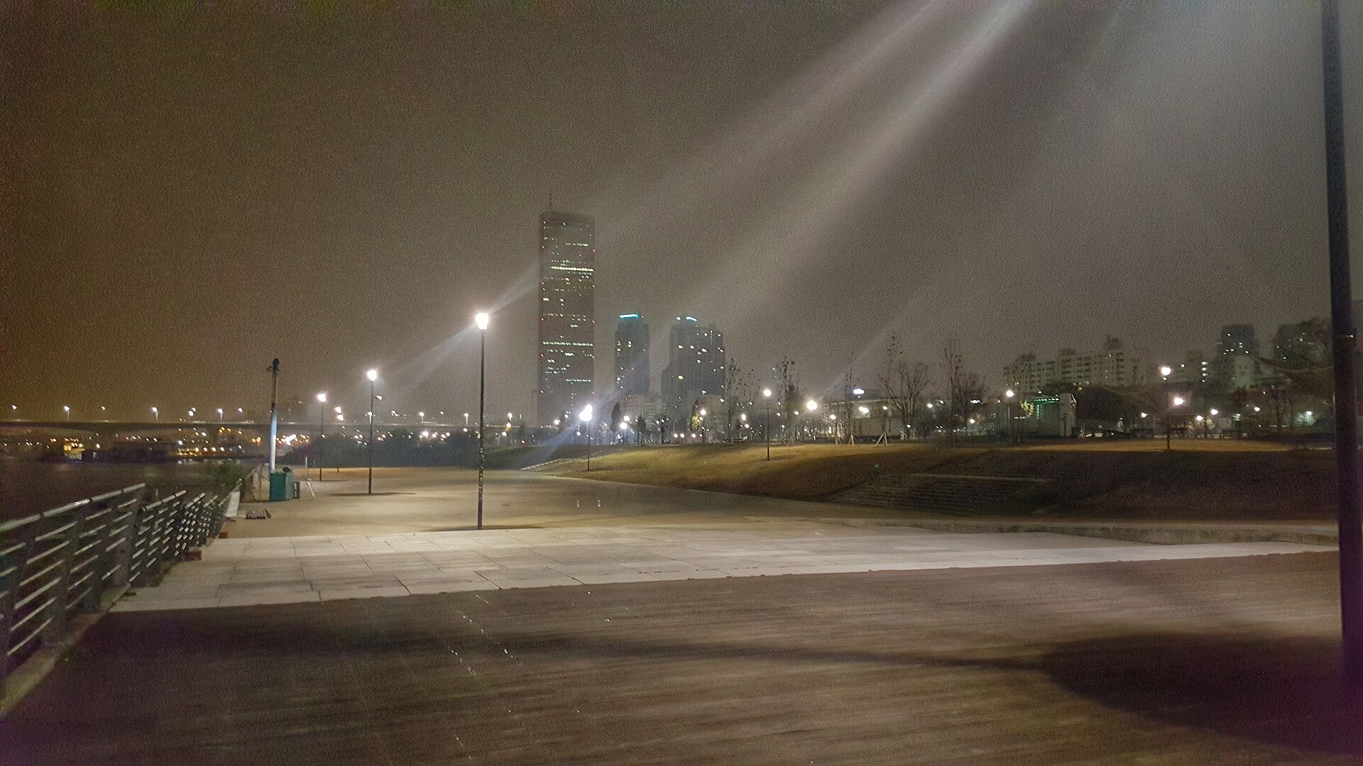 Yeouido Han River Park at night with the 63 Building lit up across the water